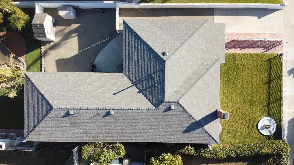 Aerial view of a freshly installed gray shingle roof